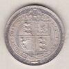 1887 Silver Shilling coin featuring Queen Victoria on the Obverse. The Reverse features the crowned Royal shield within Garter, with divided date below.