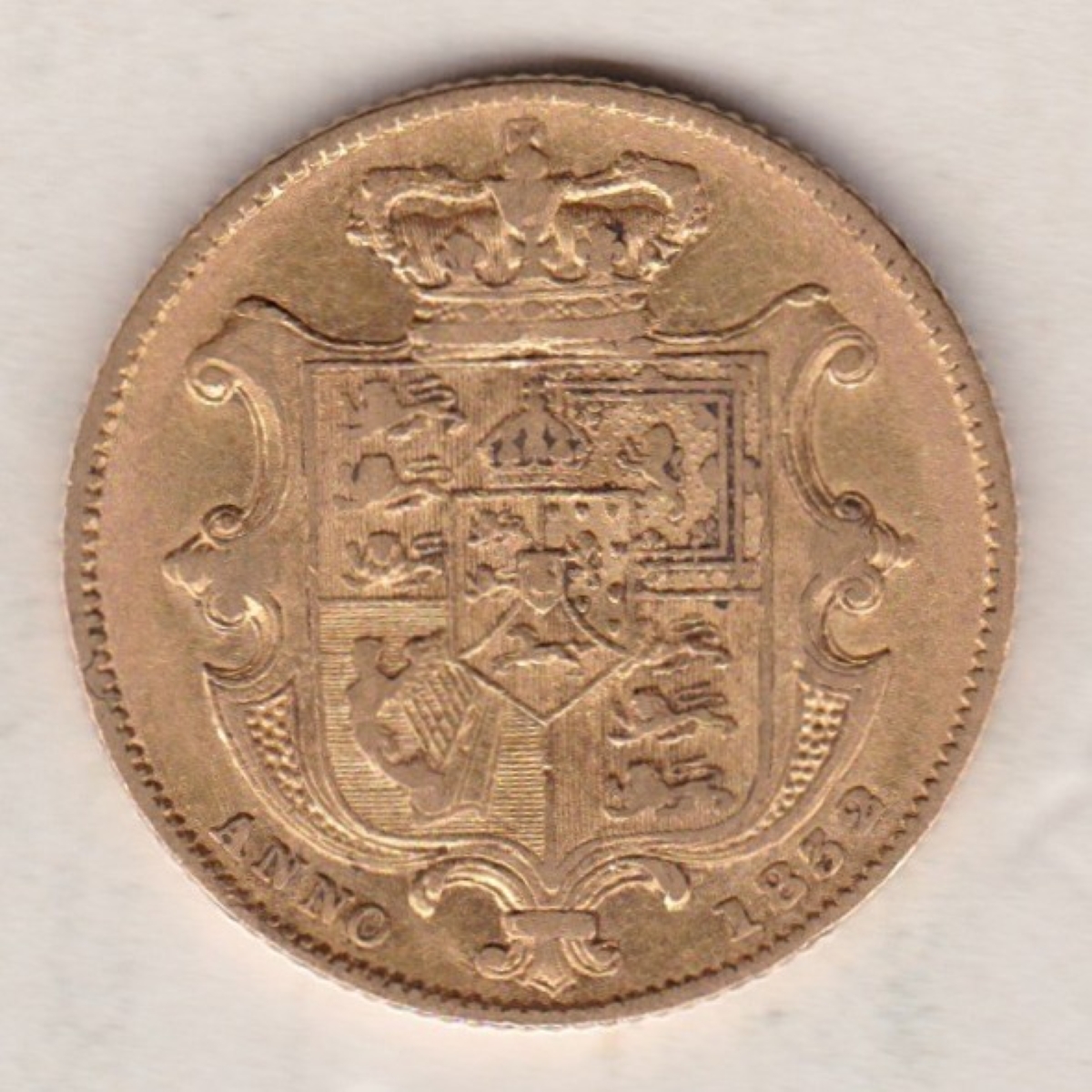 1832 Gold Sovereign Coin. This gold coin features William IV on the obverse. A crowned shield of arms and mantle, legend around on the reverse.