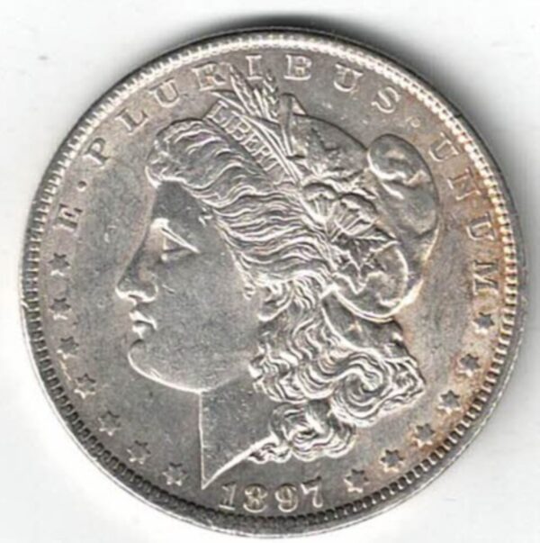 1897 Silver USA Morgan Dollar coin featuring lady liberty on the obverse. The eagle holding arrows and an olive branch on the reverse.