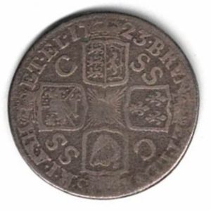 1723 silver shilling coin featuring a laureate and draped bust of George I. The crowned cruciform shields with central Garter star on the Reverse.