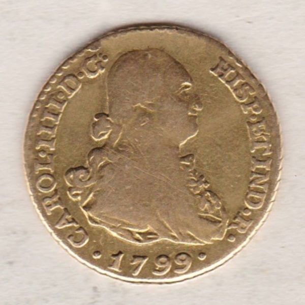 1799 Spain Gold One Escudo coin. The portrait of King Charles IIII facing right on the obverse. The reverse features crowned coat of arms of Spain.