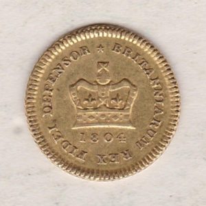 1804 Gold Third Guinea Coin featuring the laureate head portrait of King George III on the obverse. The reverse central crown with legend around and date.