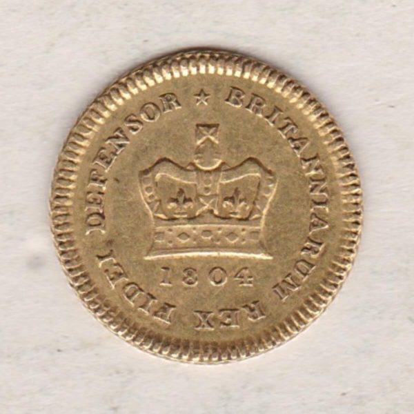 1804 Gold Third Guinea Coin featuring the laureate head portrait of King George III on the obverse. The reverse central crown with legend around and date.