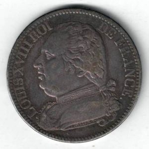 1814 A France Silver Five Francs coin featuring Louis XVIII on the Obverse. The reverse features Crowned shield of France between two olive branches letters
