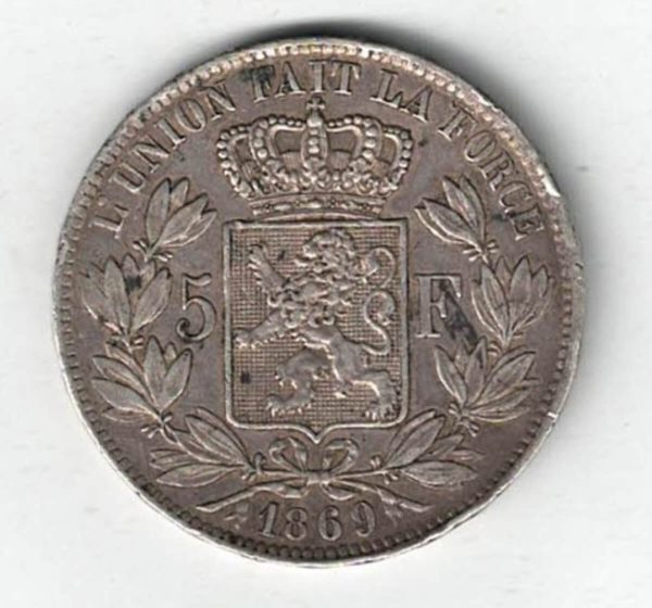 1869 Belgium Silver Five Francs Coin. The obverse features Leopold II facing left. The reverse features Crowned arms on ornate shield divide denomination.