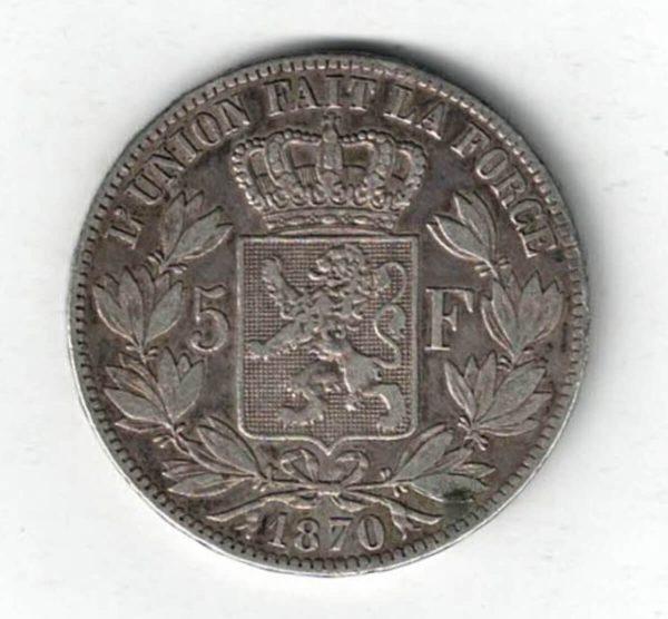 1870 Belgium Silver Five Francs Coin. The obverse features Leopold II facing left. The reverse features Crowned arms on ornate shield divide denomination.