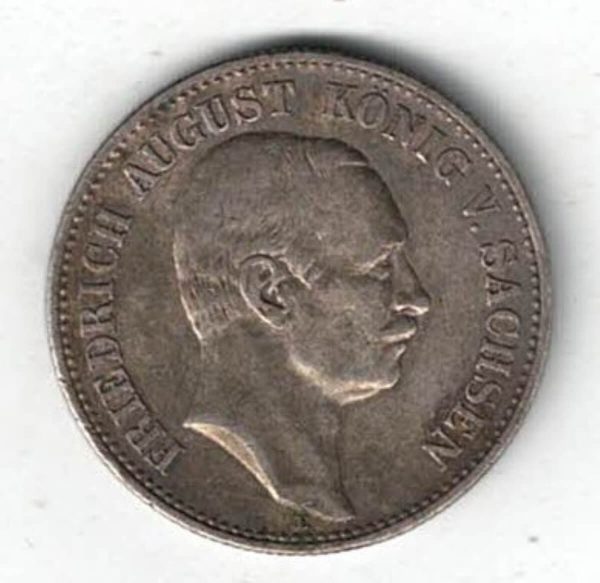 1906 E Germany Silver Two Mark Coin features the bust of Fredrich August III. The reverse features a crowned imperial eagle with shield on breast
