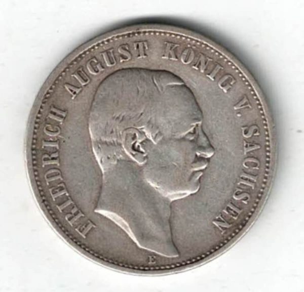 1908 E Germany Silver Three Mark Coin features the bust of Fredrich August III. The reverse features a crowned imperial eagle with shield on breast