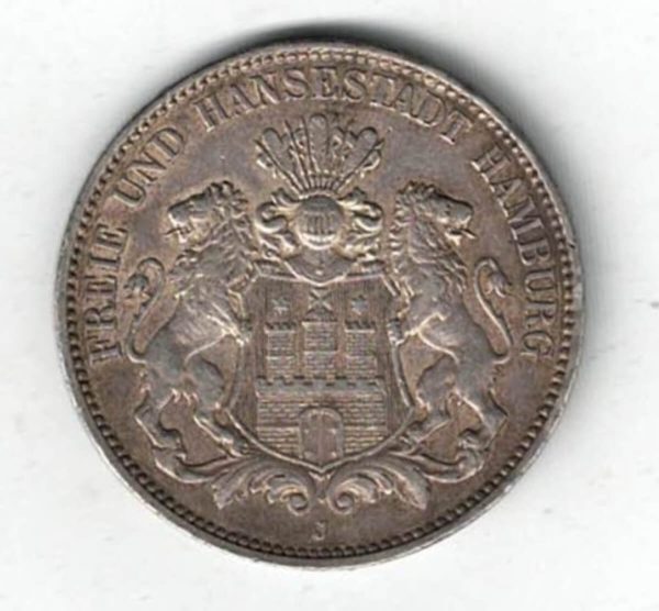 1914 J Germany Silver 3 Mark features features three tower castle on helmeted shield with supporters. The Reverse Crowned imperial eagle, shield on breast