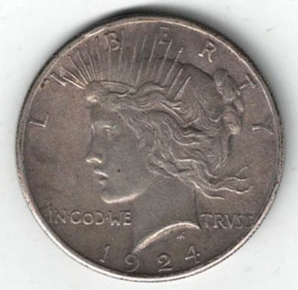 1924 Silver USA Peace Dollar coin. The Obverse features the capped head of Liberty facing left. The American eagle on the reverse.