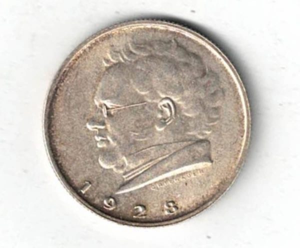 1928 Austria Silver Two Schillings Coin. The obverse features Value within circle of shields. The reverse features the head of Franz Schubert facing left.