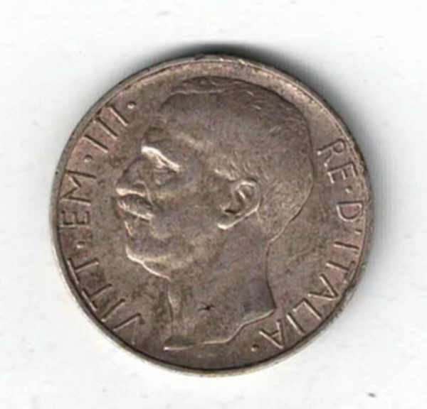 1928 R Italy Silver Ten Lire Coin. The Obverse features Victor Emmanuel III facing left. The reverse has Italy holding fasces with her left arm on a biga