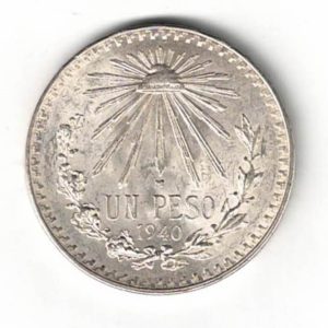 1940 Mexico Silver One Peso Coin. The obverse features the Mexican coat of arms. The reverse features the radiant cap with denomination and wreath below