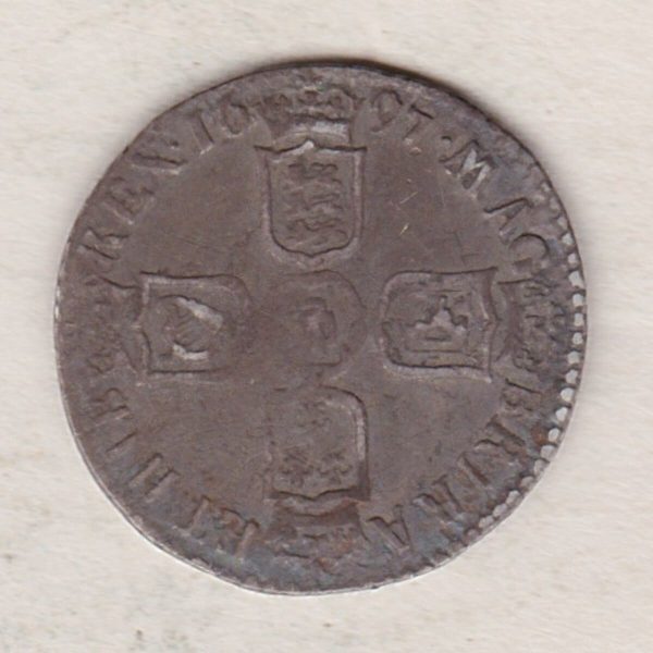 1697 E silver sixpence coin featuring King William III on the obverse. The Reverse is completed with crowned cruciform shields around central lion.