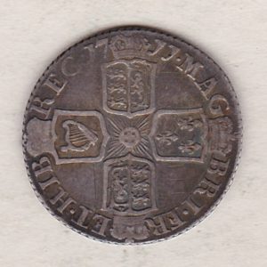 1711 silver sixpence coin featuring Queen Anne on the obverse. The Reverse is completed with crowned cruciform shields around central Garter star.