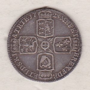 1728 silver sixpence coin featuring a laureate bust of George II. There are four crowned shields arranged in a cross on the Reverse.