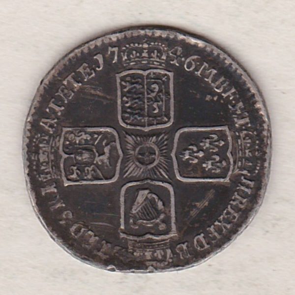 1746 Lima silver sixpence coin featuring a laureate bust of George II. There are four crowned shields arranged in a cross on the Reverse.