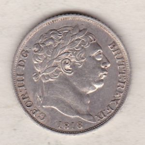 1818 silver sixpence coin featuring King George III on the Obverse. The Reverse features a crowned quartered shield of arms.
