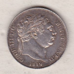 1819 silver sixpence coin featuring King George III on the Obverse. The Reverse features a crowned quartered shield of arms.
