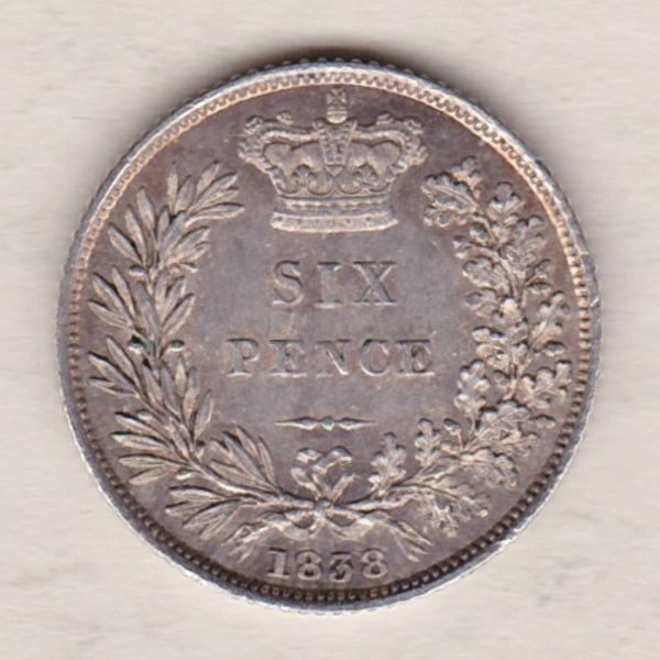 1838 silver sixpence coin featuring young head Queen Victoria on the Obverse. The crowned denomination within a wreath and date below on the Reverse.