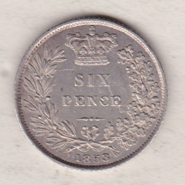 1853 silver sixpence coin featuring young head Queen Victoria on the Obverse. The crowned denomination within a wreath and date below on the Reverse.