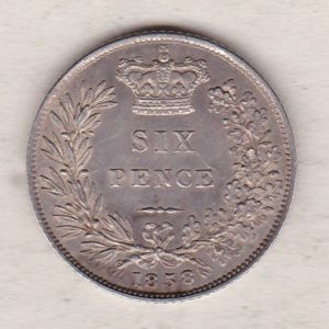 1858 silver sixpence coin featuring young head Queen Victoria on the Obverse. The crowned denomination within a wreath and date below on the Reverse.