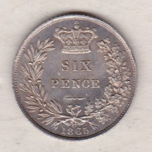 1865 silver sixpence coin featuring young head Queen Victoria on the Obverse. The crowned denomination within a wreath and date below on the Reverse.