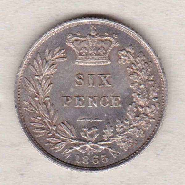 1865 silver sixpence coin featuring young head Queen Victoria on the Obverse. The crowned denomination within a wreath and date below on the Reverse.