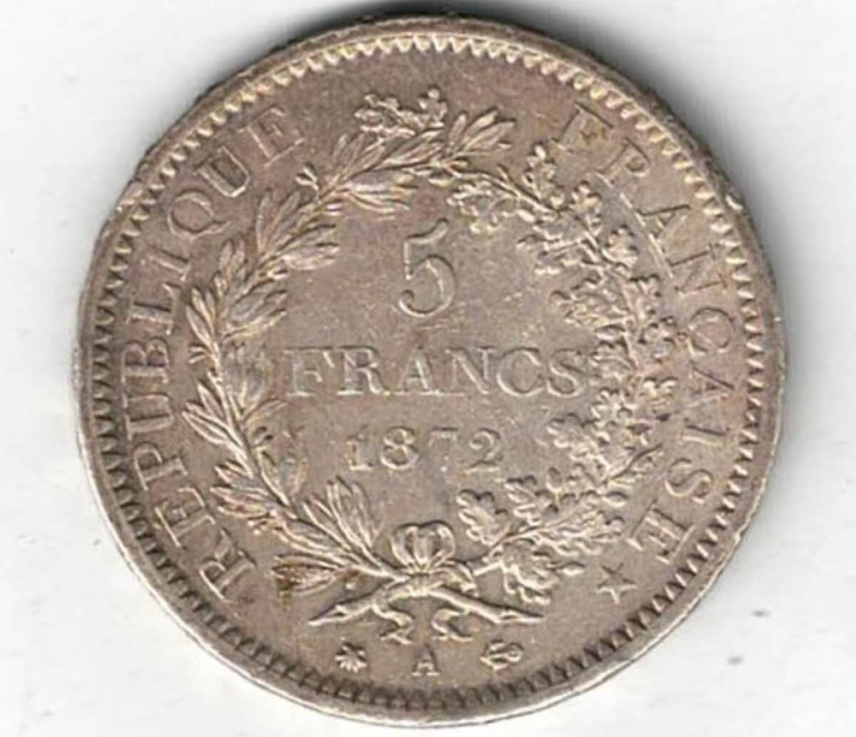 1872 A France Silver Five Francs Coin. The obverse features denomination and date within a wreath. The reverse features Hercules group with exergue below.