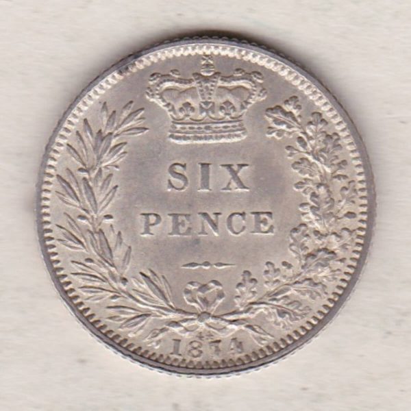 1874 silver sixpence coin featuring young head Queen Victoria on the Obverse. The crowned denomination within a wreath and date below on the Reverse.