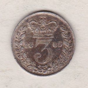 1885 Silver Threepence coin featuring the portrait of Queen Victoria on the Obverse. The Reverse features a crowned denomination dividing the date.