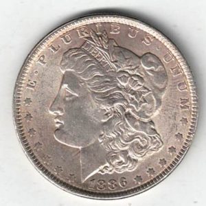 1886 Silver USA Morgan Dollar coin featuring lady liberty on the obverse. The eagle holding arrows and an olive branch on the reverse.