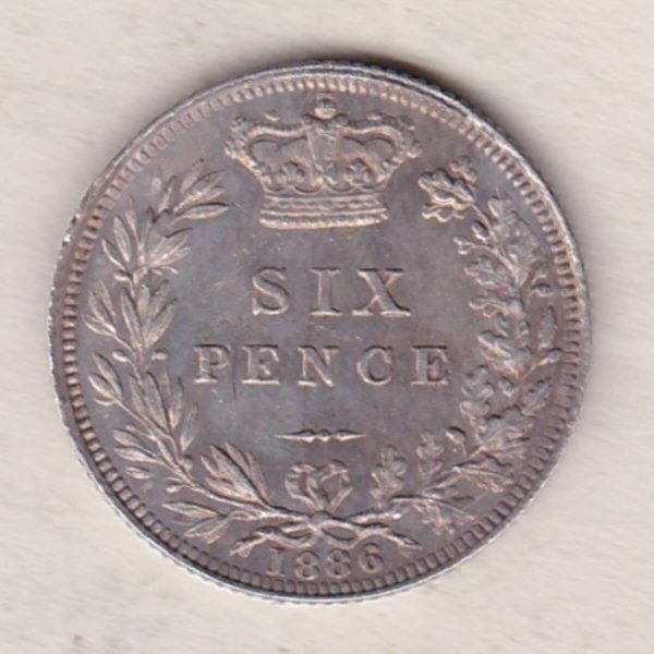 1886 Silver Sixpence coin featuring Queen Victoria on the Obverse. The Reverse features a crowned denomination within wreath.