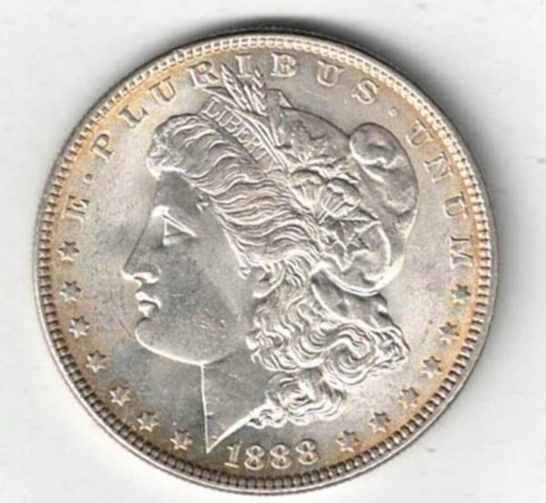 1888 Silver USA Morgan Dollar coin featuring lady liberty on the obverse. The eagle holding arrows and an olive branch on the reverse.