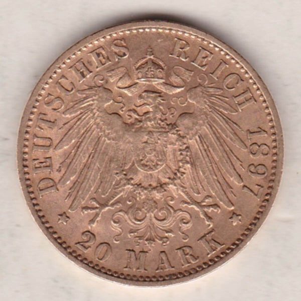 1897 F Germany Gold Twenty Mark coin featuring the bust of Wilhelm II on the obverse. The crowned imperial eagle on the reverse.