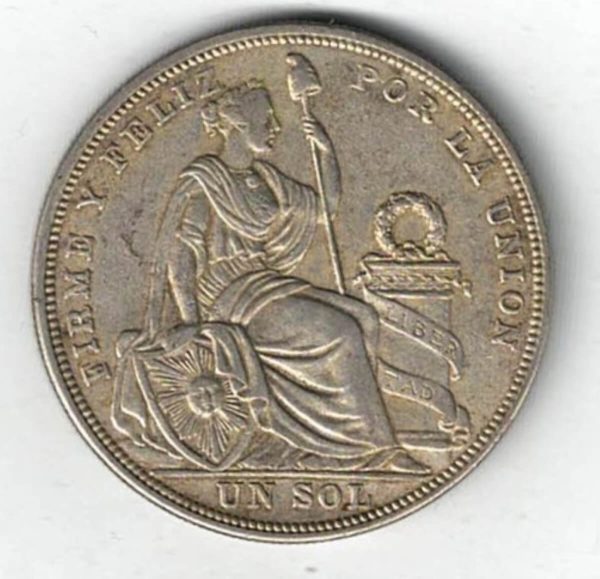 1923 Peru Silver One Sol Coin. The obverse features the national arms. The reverse features seated liberty flanked by shield and column.