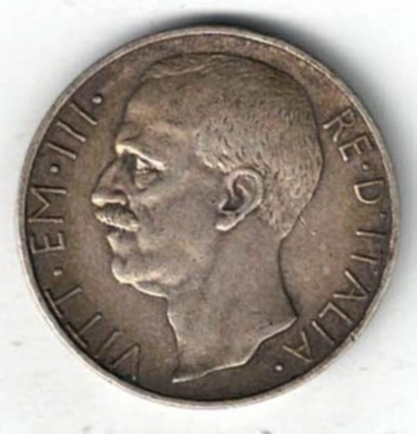1927 R Italy Silver Ten Lire Coin. The Obverse features Victor Emmanuel III facing left. The reverse has Italy holding fasces with her left arm on a biga