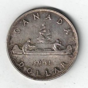 1951 Canada Silver One Dollar Coin. The obverse side of the coin features George VI facing left. The reverse features an aboriginal traveling by canoe.