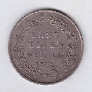 1812 Silver Three Shillings emergency issue bank token. The token features the laureate portrait of King George III on the obverse.