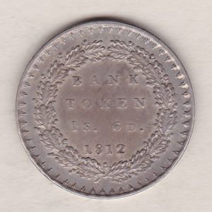 1812 Silver One Shilling And Sixpence Bank Token emergency issue bank token. The token features the laureate portrait of King George III on the obverse.