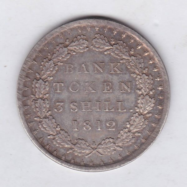 1812 Silver Three Shillings Bank Token emergency issue bank token. The token features the laureate portrait of King George III on the obverse.