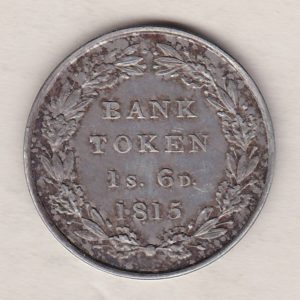 1815 Silver One Shilling And Sixpence emergency issue bank token. The token features the laureate portrait of King George III on the obverse.