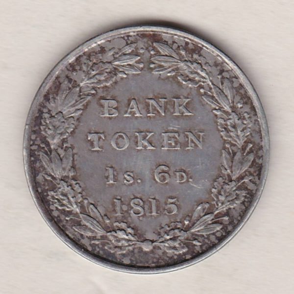 1815 Silver One Shilling And Sixpence emergency issue bank token. The token features the laureate portrait of King George III on the obverse.