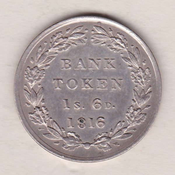 1816 Silver One Shilling And Sixpence emergency issue bank token. The token features the laureate portrait of King George III on the obverse.