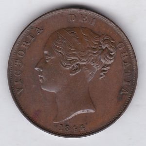 1844 copper penny coin featuring the young head portrait of Queen Victoria on the Obverse. The coin depicts Britannia seated to the right on the Reverse.
