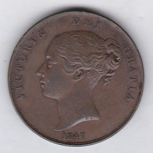 1847 copper penny coin featuring the young head portrait of Queen Victoria on the Obverse. The coin depicts Britannia seated to the right on the Reverse.