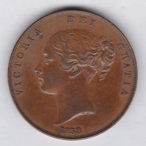 1858 copper penny coin featuring the young head portrait of Queen Victoria on the Obverse. The coin depicts Britannia seated to the right on the Reverse.