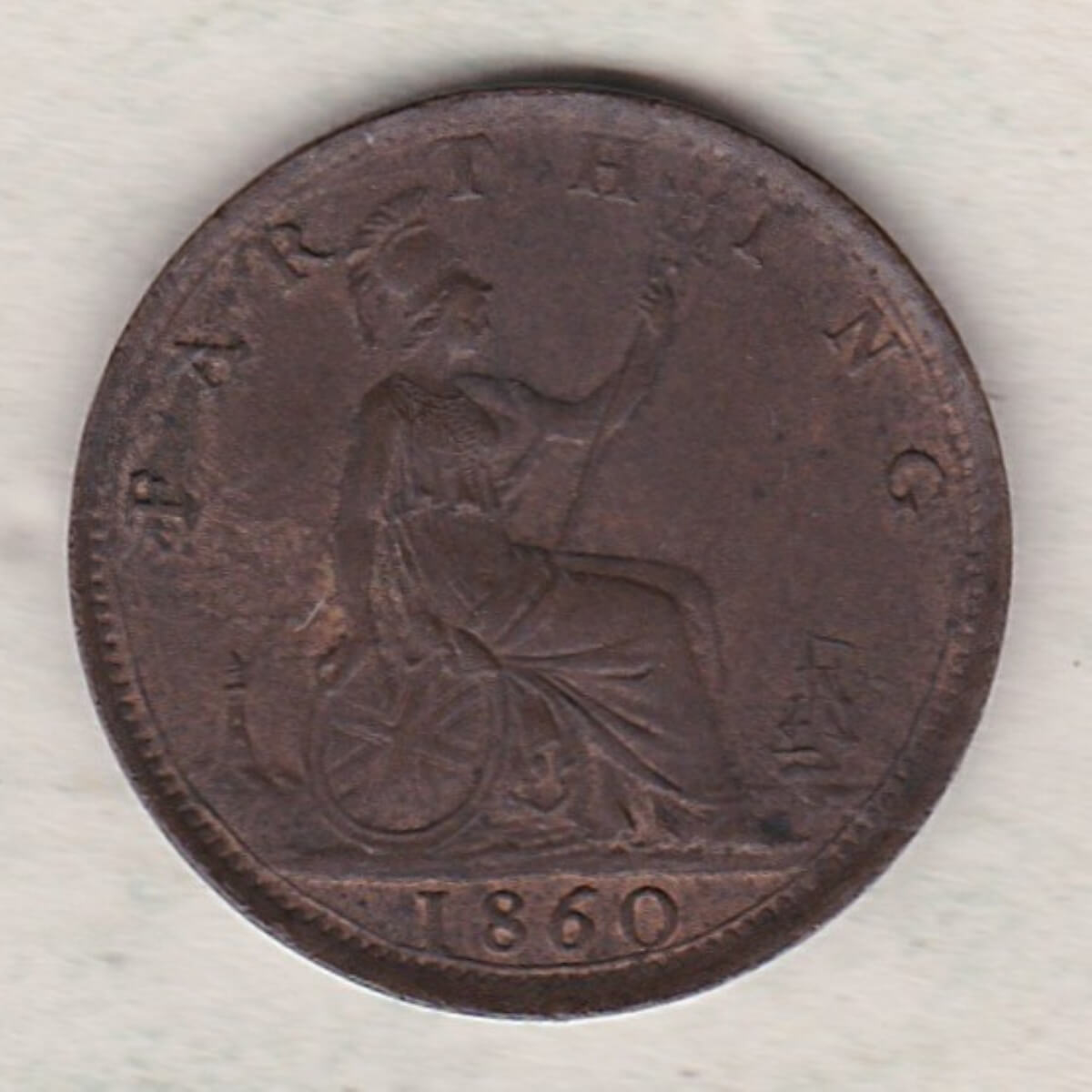 1860 Toothed Boarder Bronze farthing coin featuring the young head Queen Victoria on the Obverse. Britannia seated facing right on the Reverse.