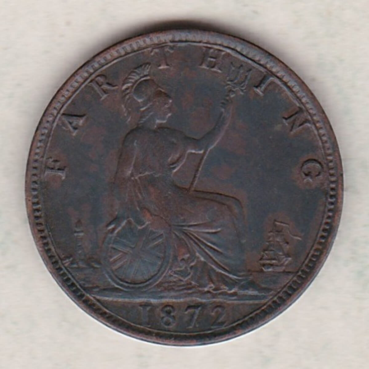 1872 bronze farthing coin featuring the young head Queen Victoria on the Obverse. Britannia seated facing right on the Reverse.