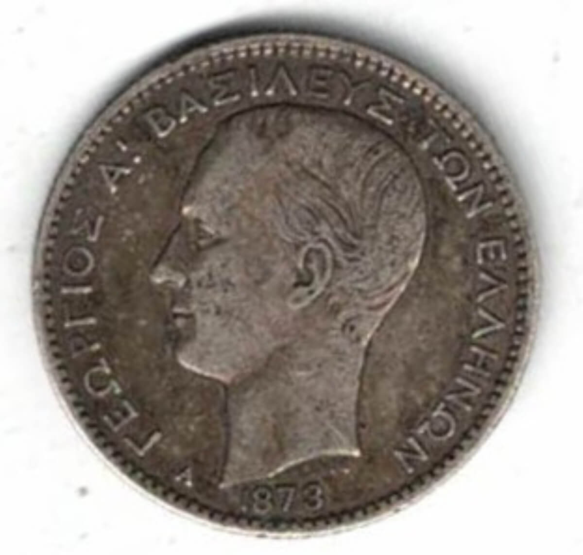 1873 A Greece One Drachmai Coin . The obverse features George I, The reverse features arms within the crowned mantle with denomination below.